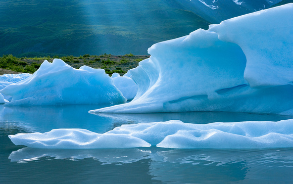 Icebergs in an ever-changing arrangement on Inner Lake George, Chugach Mountains